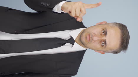 Vertical-video-of-Businessman-alerting-camera-with-stern-expression.